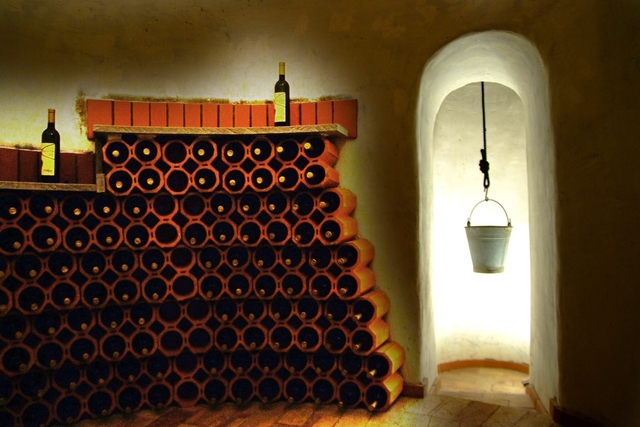 a wine cellar with a bucket from the ceiling