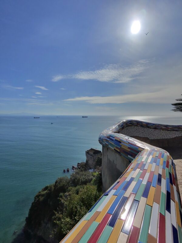 a colorful tiled wall overlooking the sea in Vietri sul mare